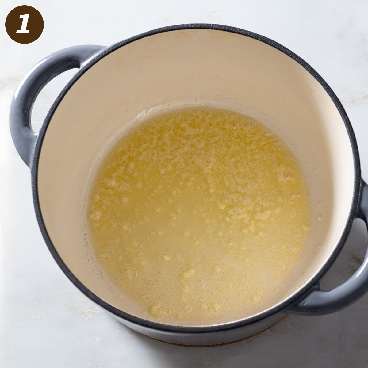 Melted butter and garlic in a pot.