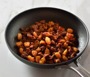 Cooked chorizo shrimp taco filling in a pan.