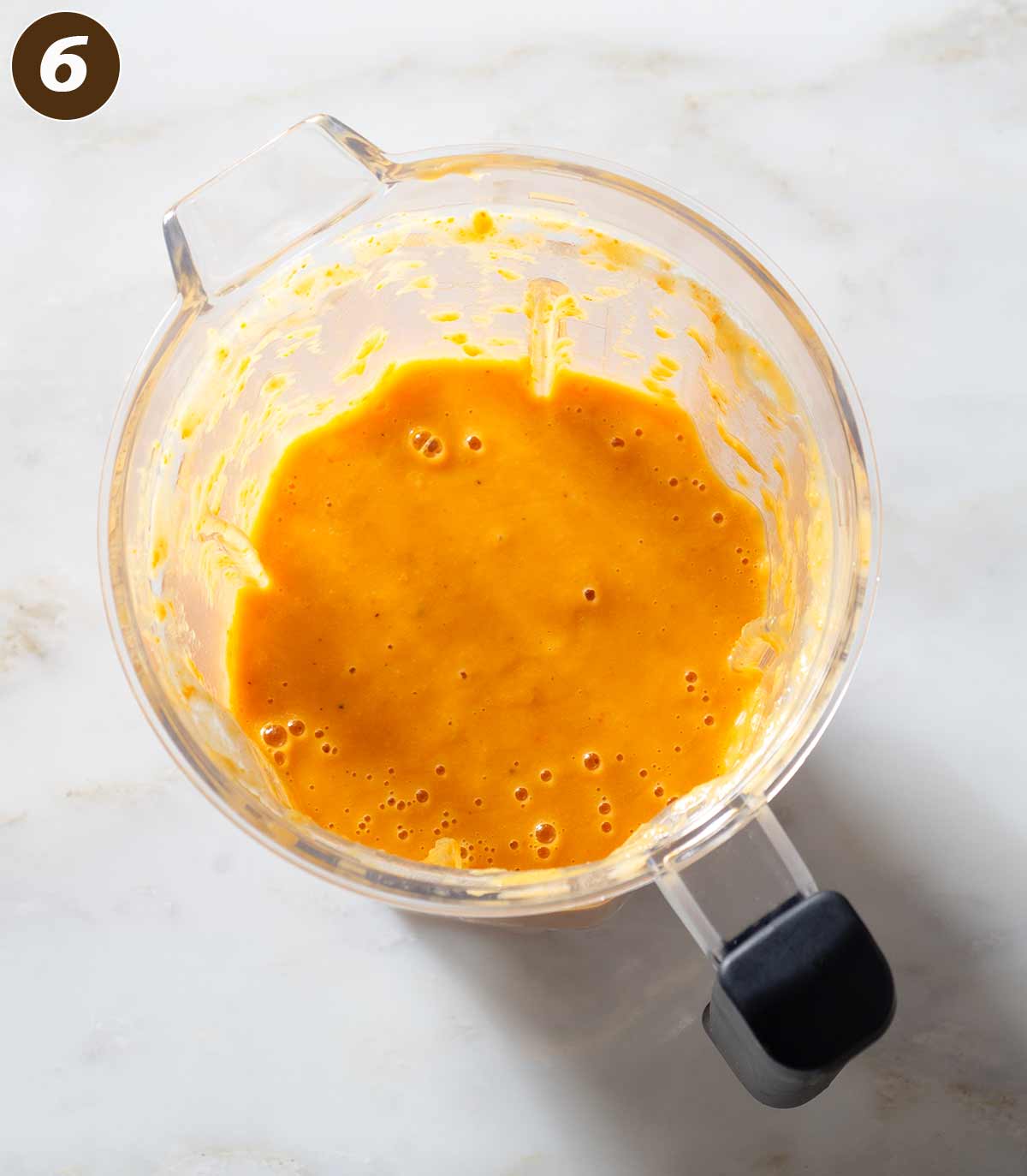 Pureed sweet potato soup in a blender.