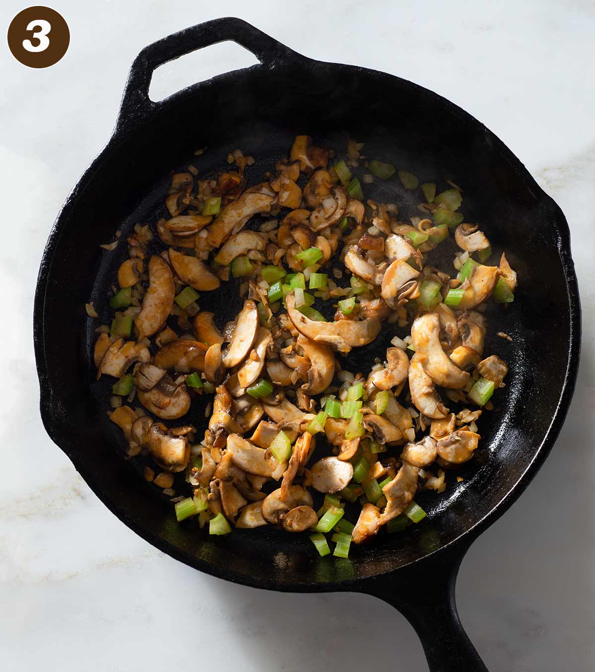 Cooked celery, onion and mushrooms in a cast iron skillet.