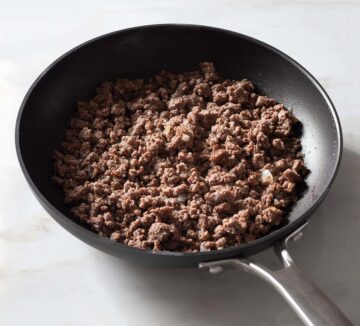 Cooked ground beef in a nonstick pan.