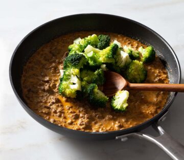 Ground beef pasta sauce with broccoli in a nonstick pan.