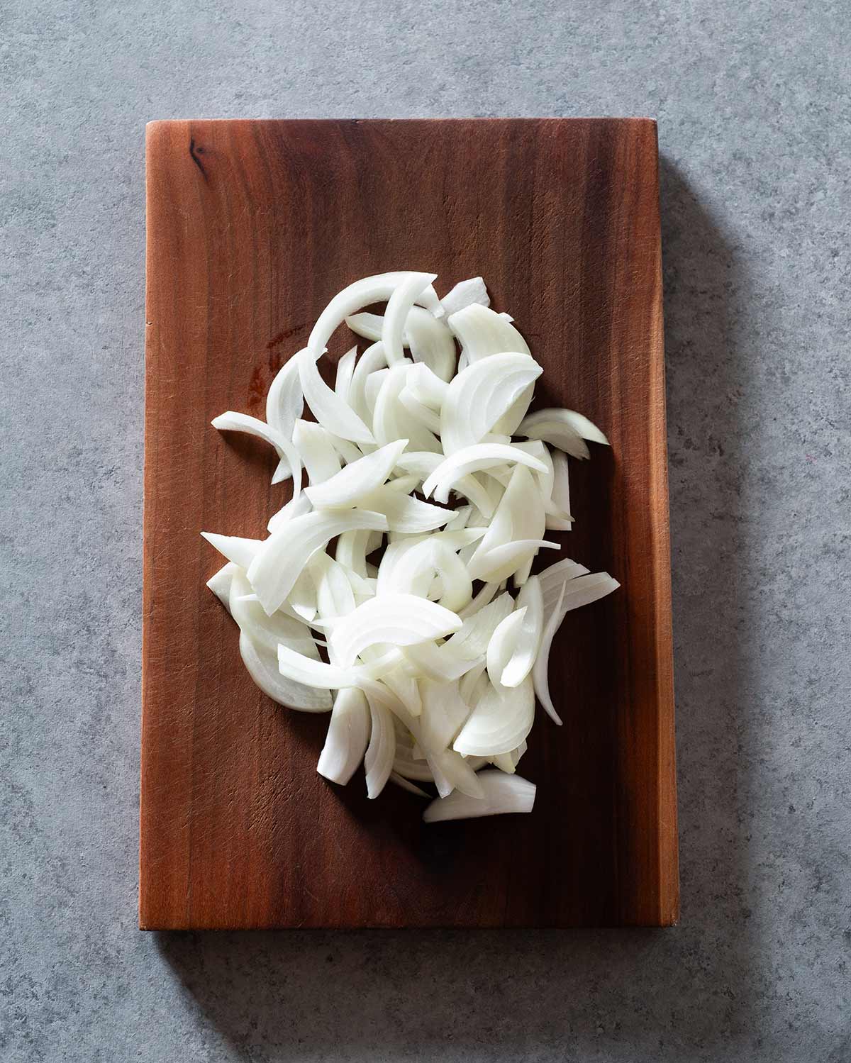 Sliced onion on a cutting board.