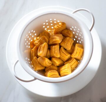 Cooked sweet potato gnocchi in a colander.