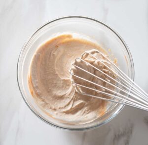 Dipping sauce being whisked in a bowl.