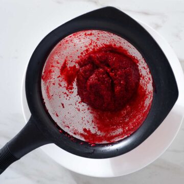 Raspberry seeds in a sieve.