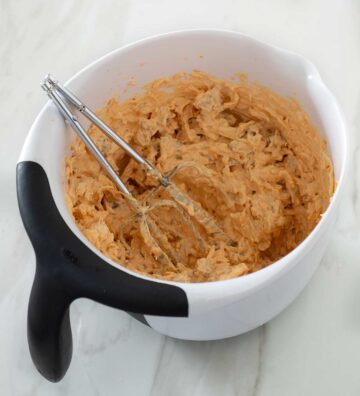 Spicy Italian sausage dip in a mixing bowl.