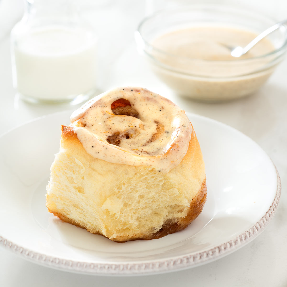 Cinnamon roll with spiced orange cream cheese glaze.