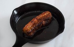 Roasted pork belly in a cast iron pan.