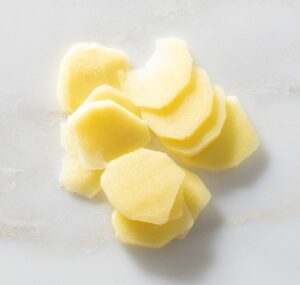 Peeled and sliced fresh ginger.
