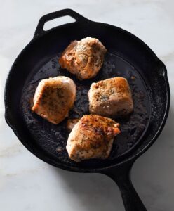Roasted pork tenderloin in a cast iron pan.