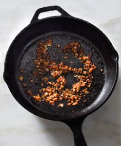 Cooked onion in a cast iron pan.