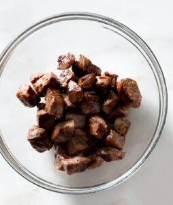 Seared steak bites in a bowl.