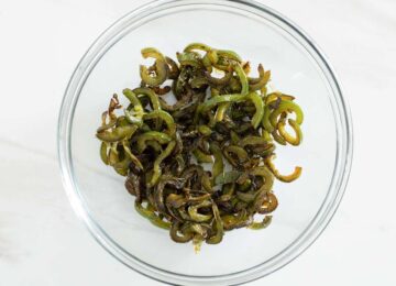 Charred jalapeno slices in a bowl.