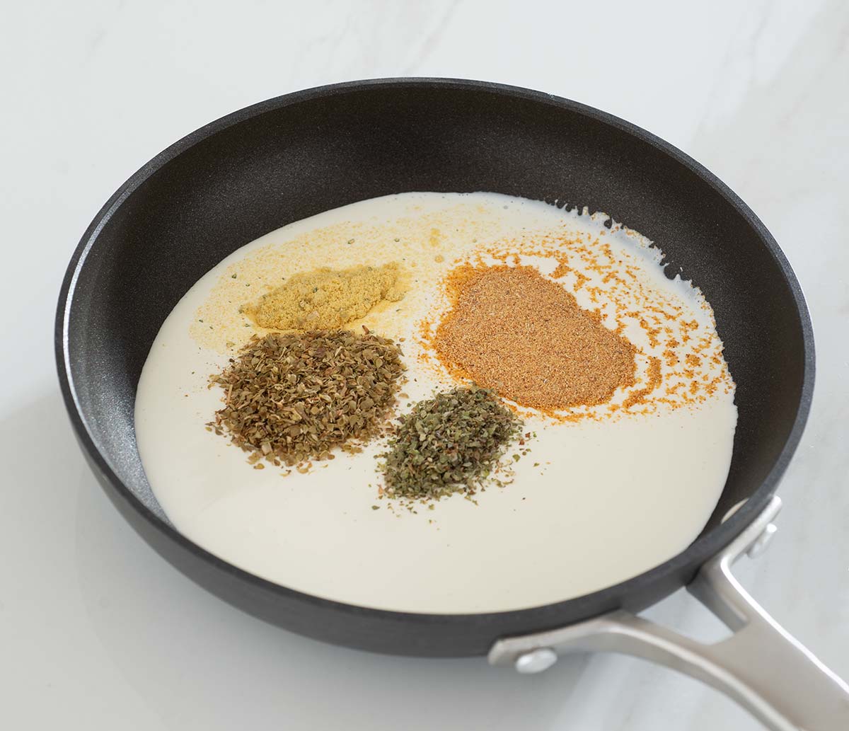 Cream and seasonings in a pan.
