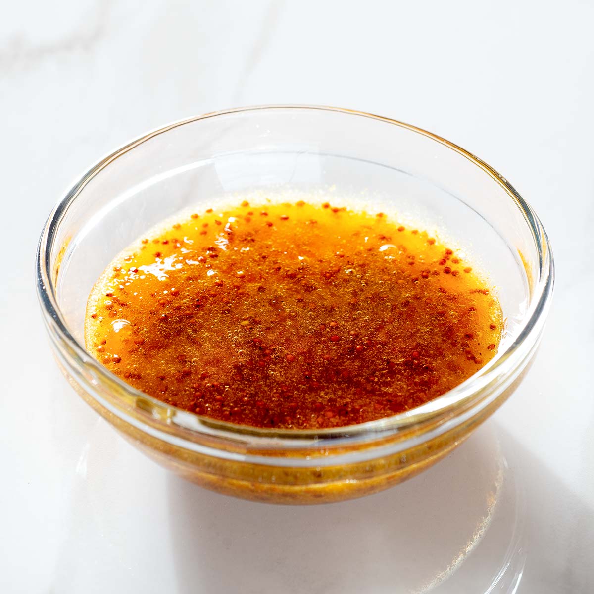 Curried peach and mustard sauce in a bowl.