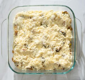 Unbaked strata in a baking dish.