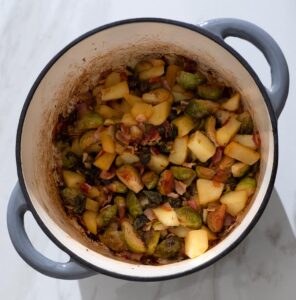 Roasted Brussels sprouts, bacon and apple in a Dutch oven.