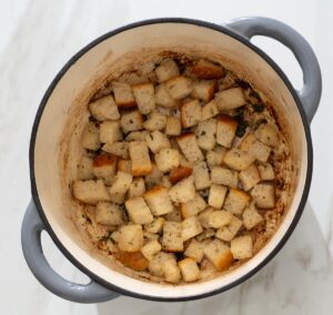 Fried bread cubes in a Dutch oven.