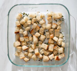 Bread cubes in a baking dish.