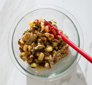 Dijon being mixed into roasted Brussels sprouts.