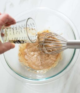 Oil being whisked into a vinaigrette.